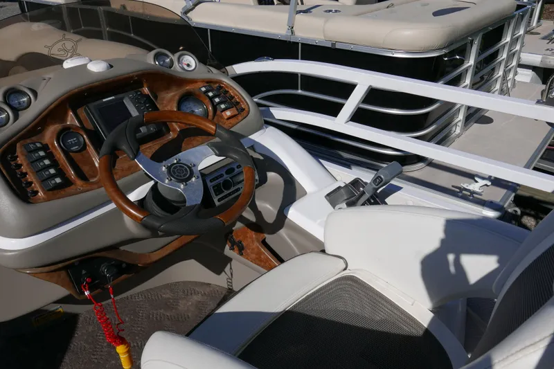 Slide: The Image of 2008 JC SunToon 21TT boat dashboard with steering wheel and control panel. - 9