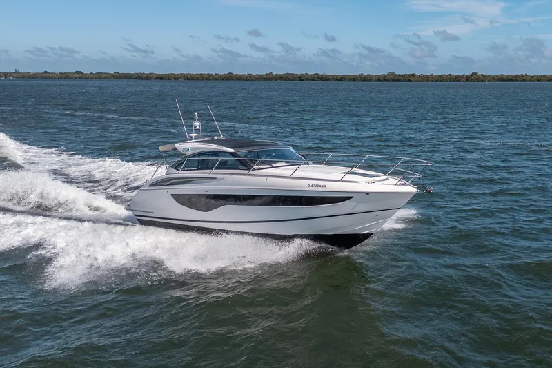 The Image of 2021 Princess V40 yacht cruising on open water under a clear blue sky. - 0