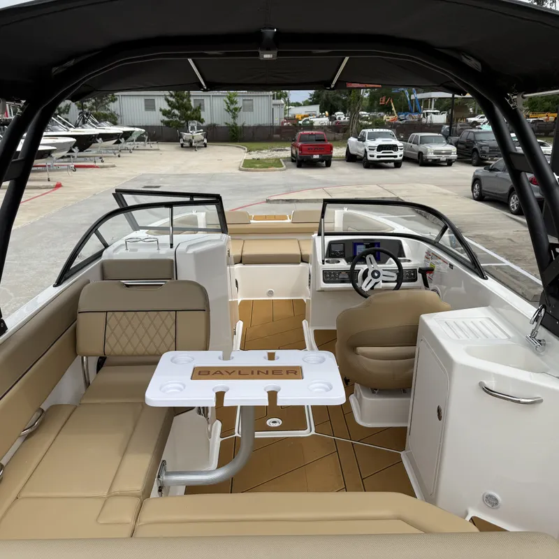 Slide: The Image of Interior of 2025 Bayliner D22I boat with beige seating and helm console. - 16