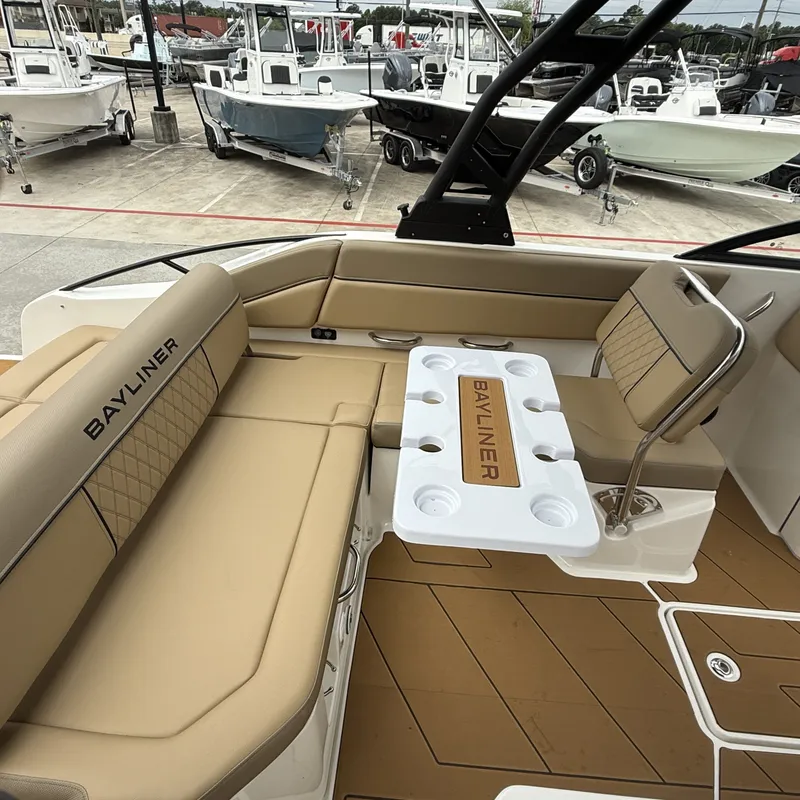 Slide: The Image of Interior of 2025 Bayliner D22I with beige seating and table. - 17