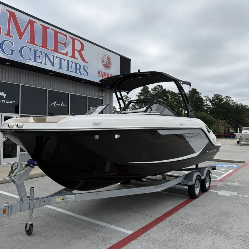 Slide: The Image of 2025 Bayliner D22I boat on trailer outside a store. - 3