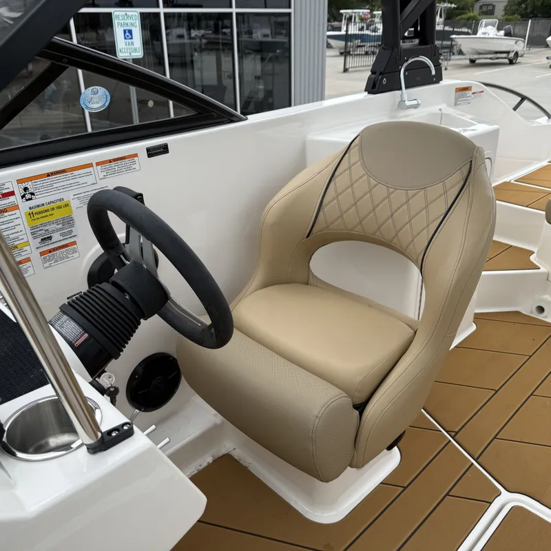 Slide: The Image of Interior of 2025 Bayliner D22I with steering wheel and seat. - 31