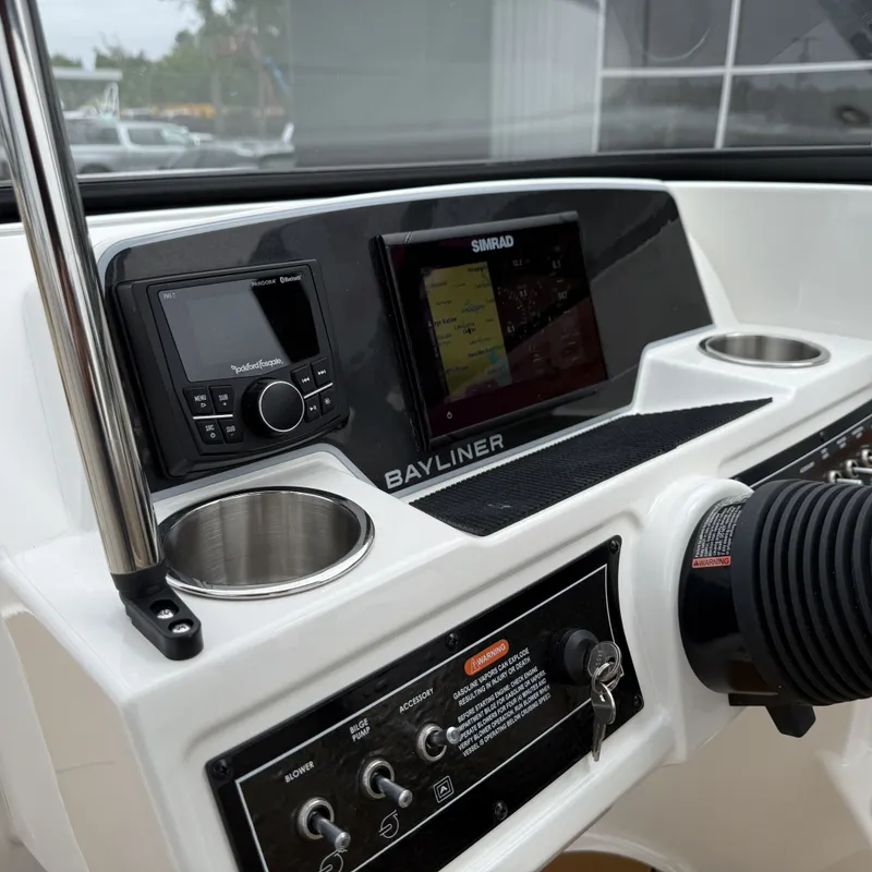 Slide: The Image of Bayliner D22I 2025 boat console with Simrad display and controls. - 32