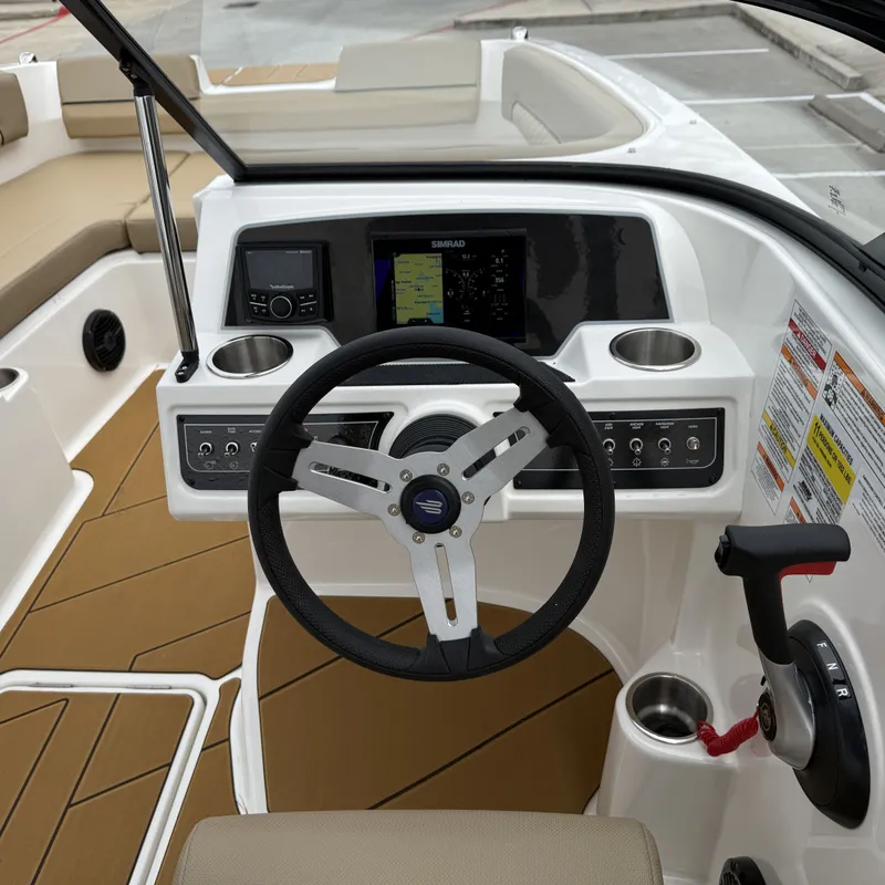 Slide: The Image of 2025 Bayliner D22I cockpit with modern steering controls. - 33