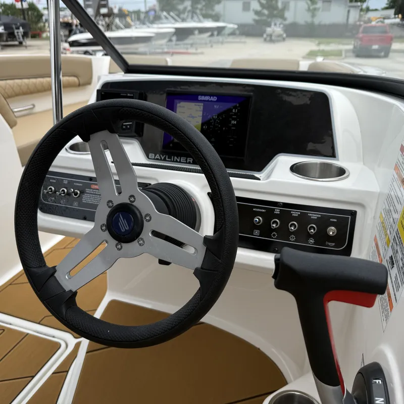 Slide: The Image of Bayliner D22I 2025 helm with steering wheel and controls. - 35