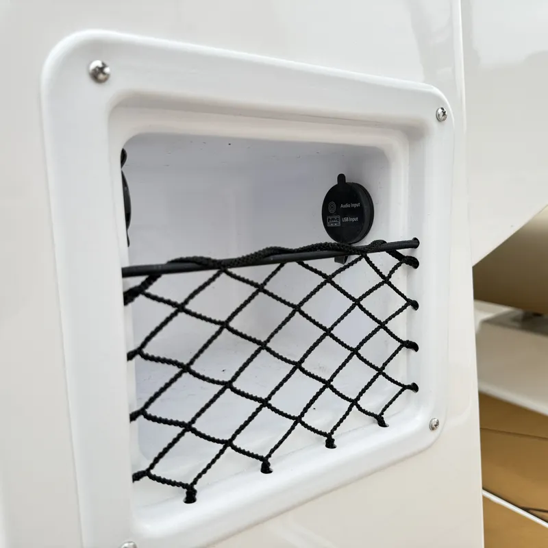 Slide: The Image of Bayliner D22I 2025 boat with netted compartment and audio input. - 39