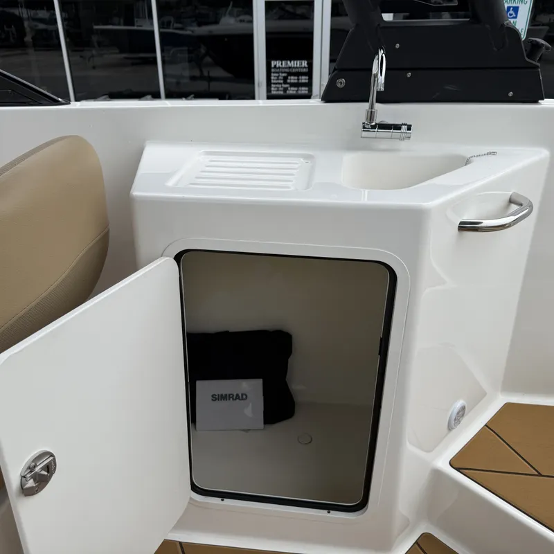 Slide: The Image of Bayliner D22I 2025 featuring sink and storage compartment. - 41