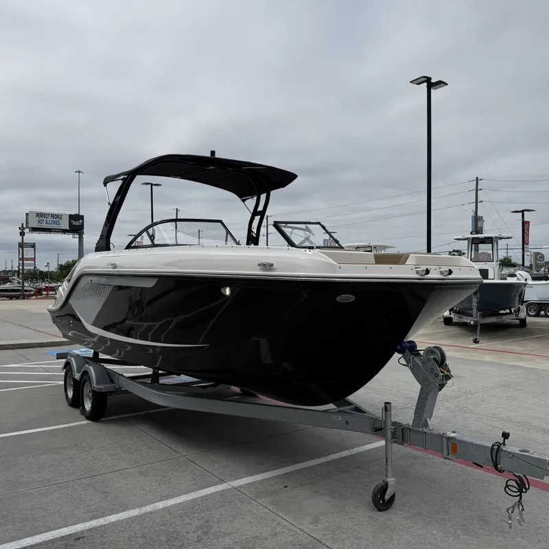 Slide: The Image of 2025 Bayliner D22I boat on trailer under cloudy sky. - 6
