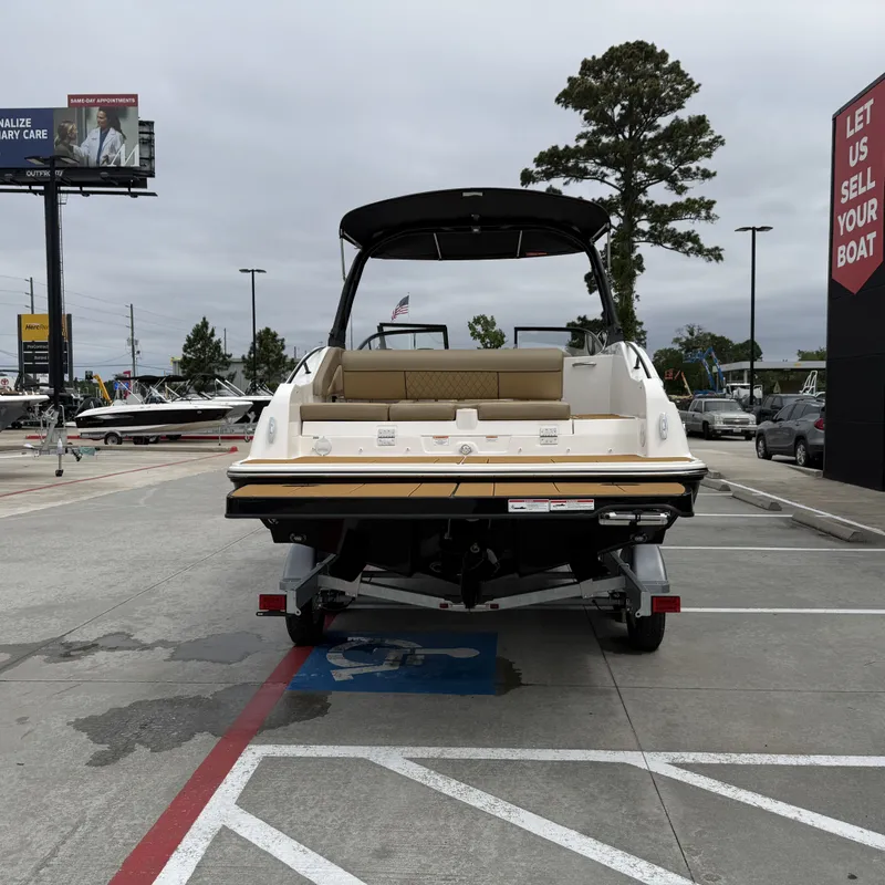 Slide: The Image of Rear view of a 2025 Bayliner D22I boat in a parking lot. - 9