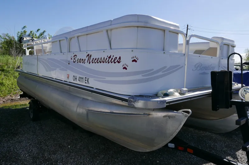 Slide: The Image of 2008 Bentley Pontoons 200 CRUISE boat on trailer, labeled "Bare Necessities." - 2