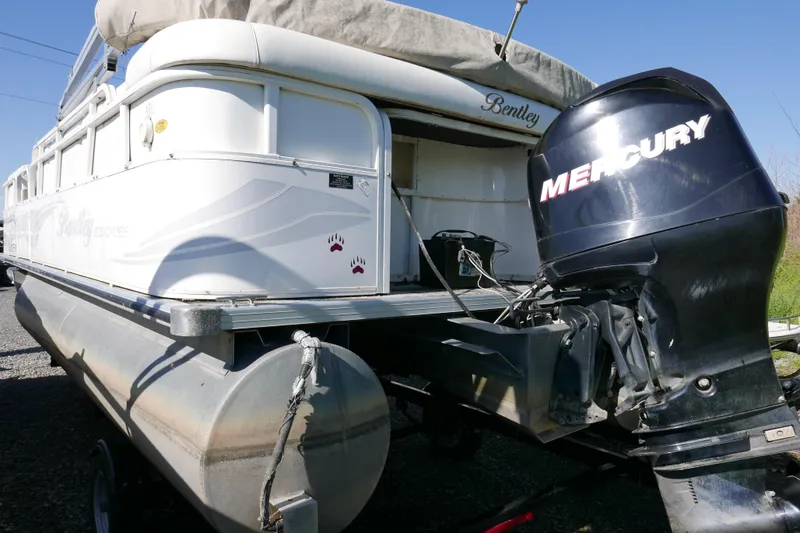 Slide: The Image of 2008 Bentley Pontoons 200 CRUISE with Mercury outboard motor, parked on a trailer. - 5