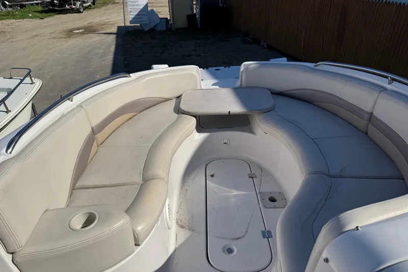 Slide: The Image of 1997 Chaparral 232 Sunesta boat interior with curved seating and table. - 12