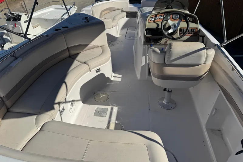 Slide: The Image of 1997 Chaparral 232 Sunesta boat interior with seating and steering console. - 14