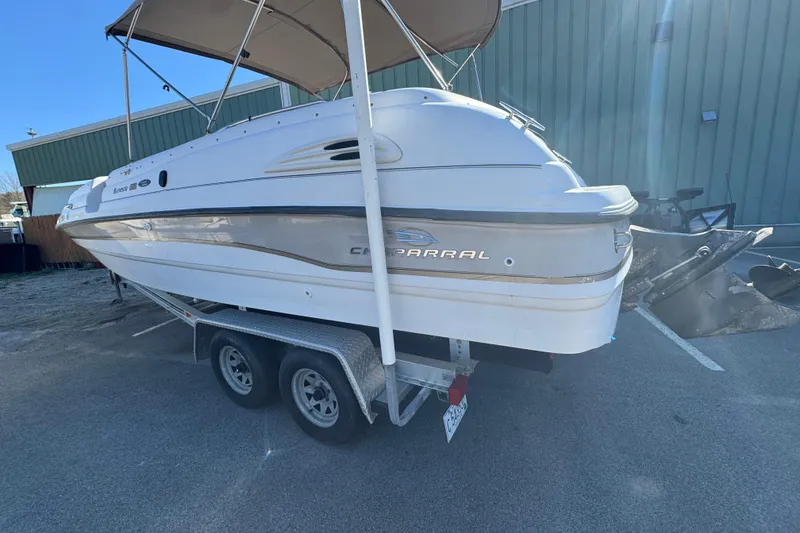 Slide: The Image of 1997 Chaparral 232 Sunesta boat on trailer, parked outdoors with canopy. - 5