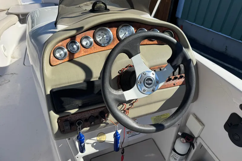 Slide: The Image of Steering console of a 1997 Chaparral 232 Sunesta boat with gauges and controls. - 8