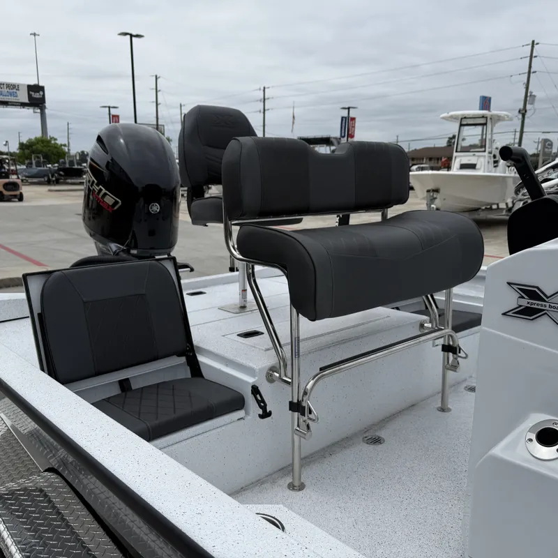 Slide: The Image of 2026 Xpress H22BAY boat with modern seating and outboard motor. - 19