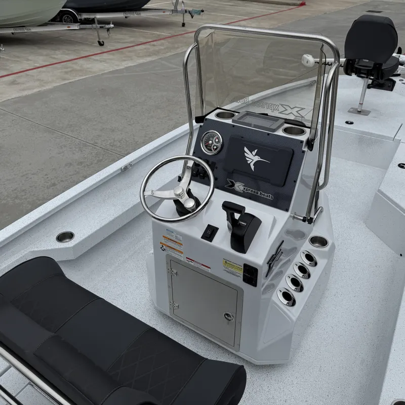 Slide: The Image of 2026 Xpress H22BAY boat console with steering and seating. - 22