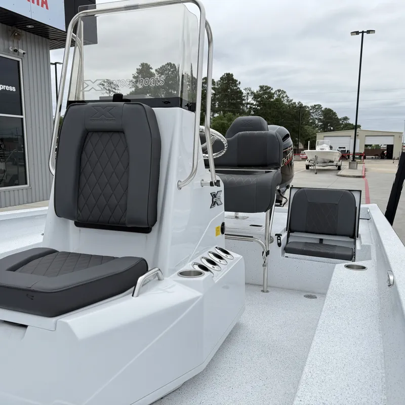 Slide: The Image of 2026 Xpress H22BAY boat with modern seating and console. - 24