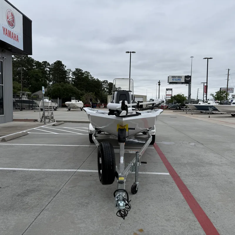 Slide: The Image of 2026 Xpress H22BAY boat on trailer at Yamaha dealership. - 5