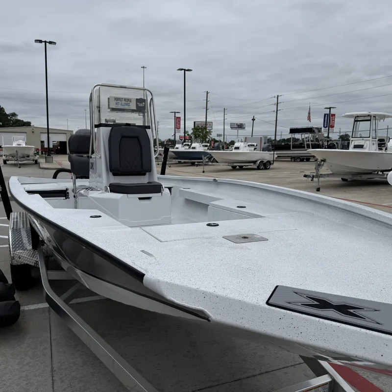 Slide: The Image of 2026 Xpress H22BAY boat displayed in a parking lot. - 6