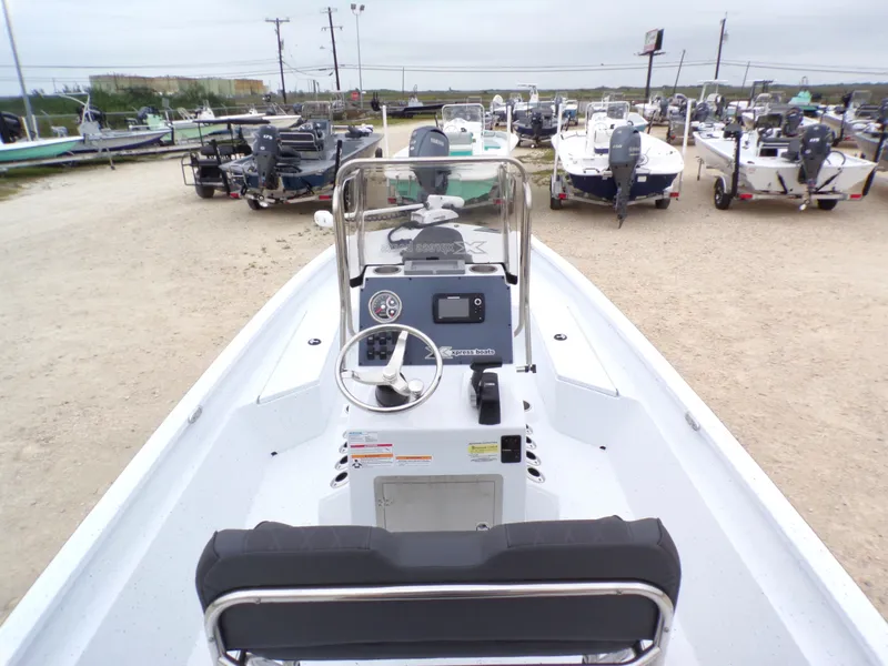 Slide: The Image of 2026 Xpress SW20B boat outdoors in a parking area. - 19