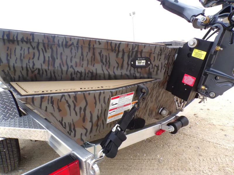 Slide: The Image of 2026 Xpress X18DB boat with camouflage pattern and trailer. - 27