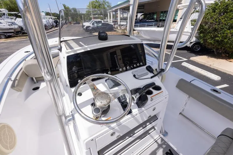 The Image of 2021 Sportsman Heritage 211 Center Console boat dashboard with steering wheel and controls. - 1