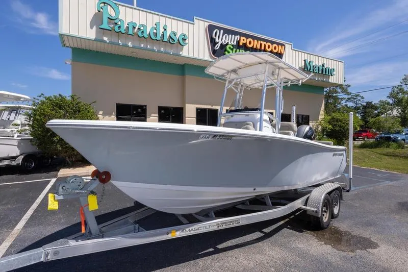 Slide: The Image of 2021 Sportsman Heritage 211 Center Console boat on trailer outside Paradise Marine store. - 12