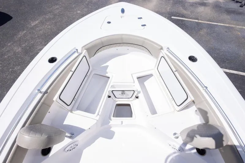 Slide: The Image of 2021 Sportsman Heritage 211 Center Console boat interior with seating and storage compartments. - 13