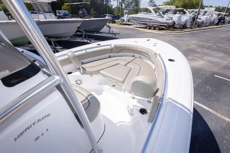 Slide: The Image of 2021 Sportsman Heritage 211 Center Console boat with spacious seating, parked in a marina. - 15