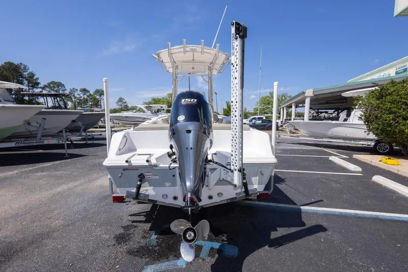 Slide: The Image of 2021 Sportsman Heritage 211 Center Console boat with outboard motor in a parking lot. - 16