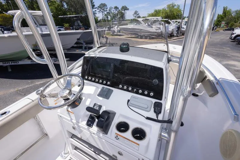 Slide: The Image of 2021 Sportsman Heritage 211 Center Console boat dashboard with steering wheel and controls. - 18