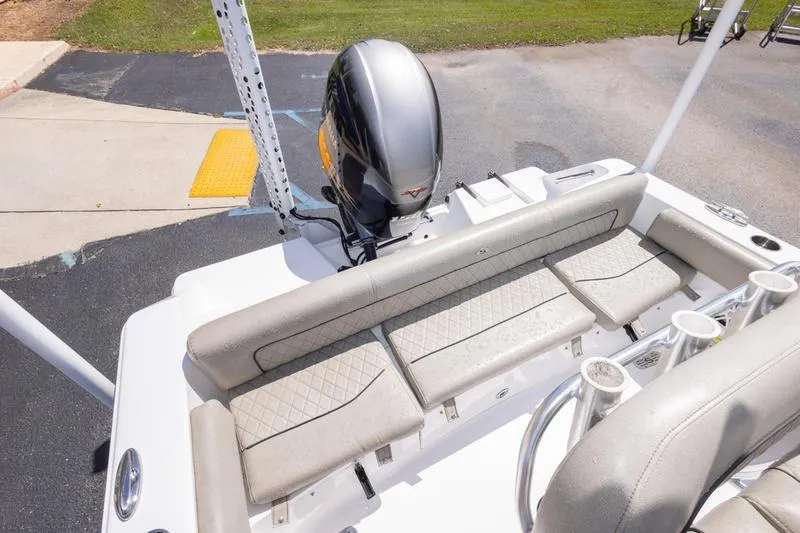 Slide: The Image of 2021 Sportsman Heritage 211 Center Console boat with cushioned seating and outboard motor. - 3