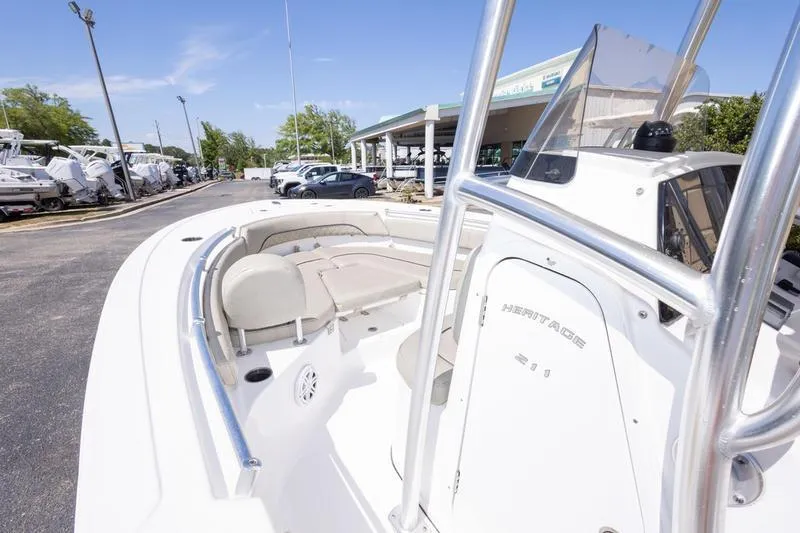 Slide: The Image of 2021 Sportsman Heritage 211 Center Console boat at a dealership, showcasing seating and console. - 6