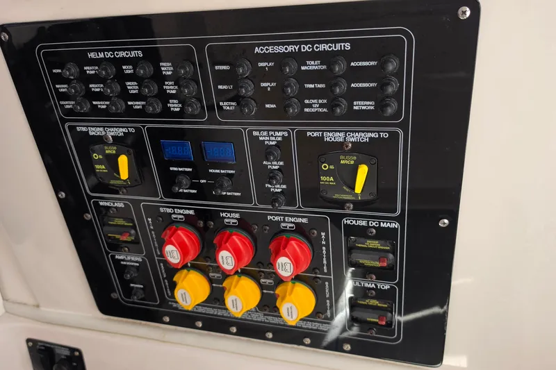 Slide: The Image of Control panel of a 2023 Sea Fox 288 Commander boat with various circuit switches. - 21