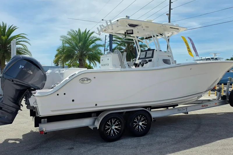 Slide: The Image of 2023 Sea Fox 288 Commander boat on trailer, featuring dual Yamaha engines. - 3