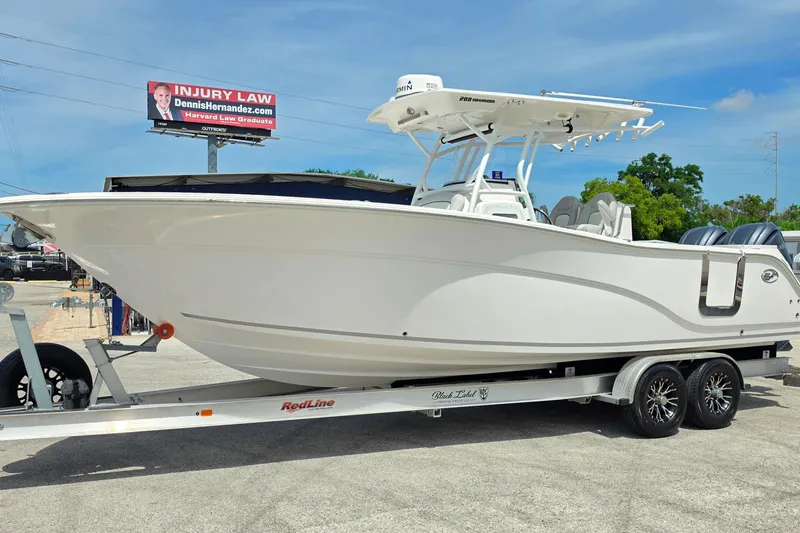 Slide: The Image of 2023 Sea Fox 288 Commander boat on trailer, displayed outdoors under clear sky. - 7