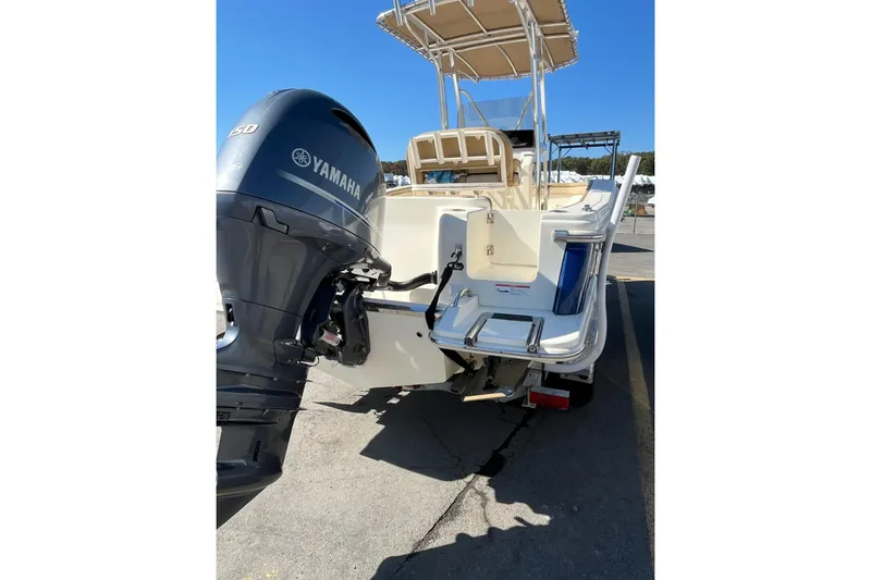 Slide: The Image of 2018 Scout 215 XSF boat with Yamaha outboard motor, parked on a trailer. - 3
