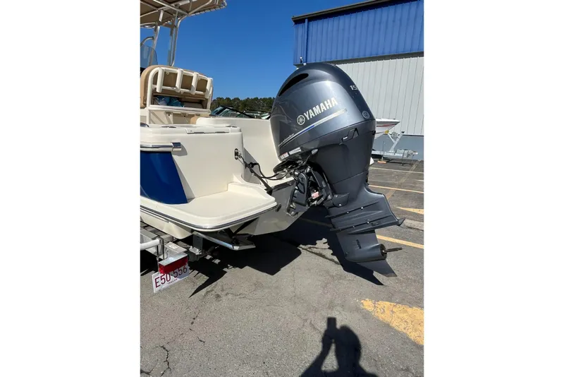 Slide: The Image of 2018 Scout 215 XSF boat with Yamaha outboard motor in a parking lot. - 4