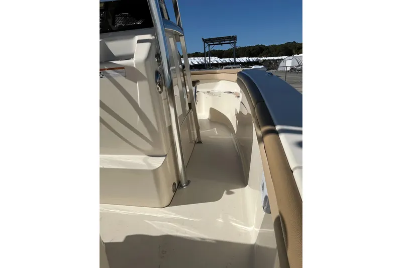Slide: The Image of 2018 Scout 215 XSF boat interior with beige seating and stainless steel accents. - 6