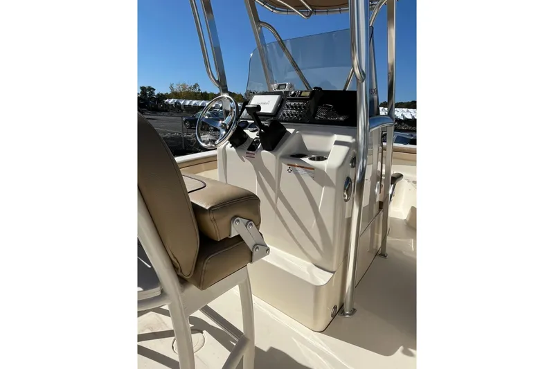 Slide: The Image of 2018 Scout 215 XSF boat interior with steering console and seating. - 7