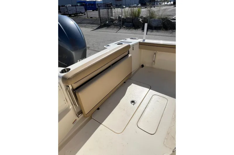 Slide: The Image of 2018 Scout 215 XSF boat interior with foldable seating and engine view. - 8