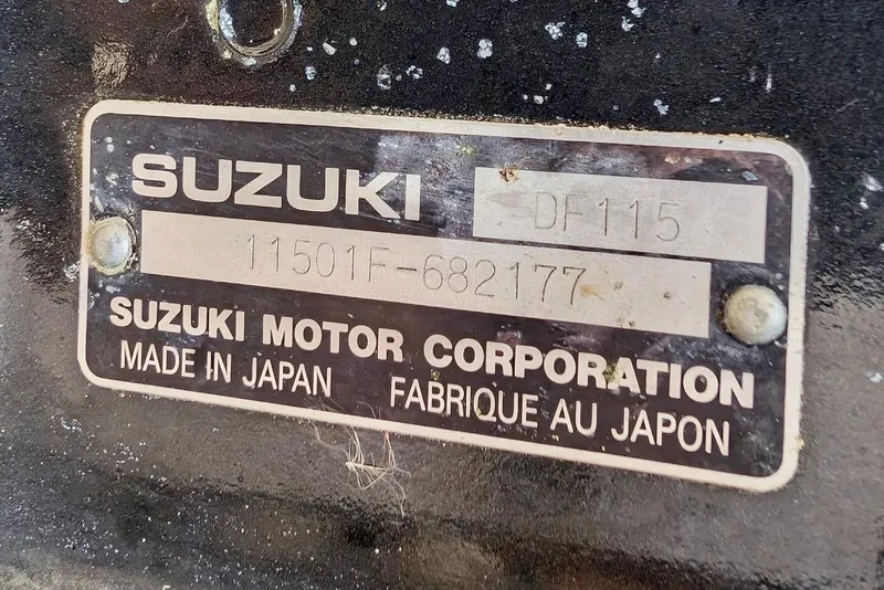 Slide: The Image of Suzuki motor plate on 2006 Twin Vee 19 BayCat, model DF115, made in Japan. - 11