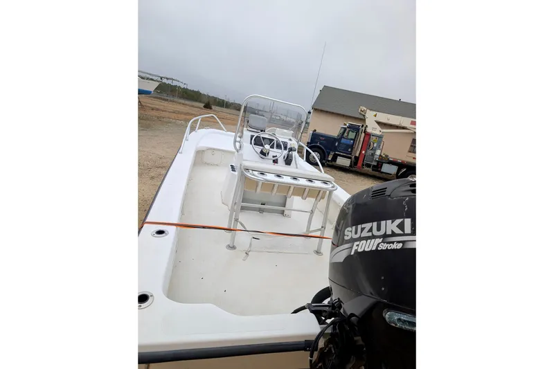 Slide: The Image of 2006 Twin Vee 19 BayCat boat with Suzuki four-stroke engine, parked outdoors. - 4