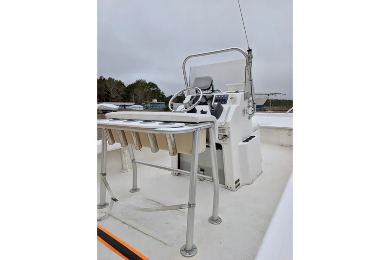 Slide: The Image of 2006 Twin Vee 19 BayCat boat interior with steering console and rod holders. - 5