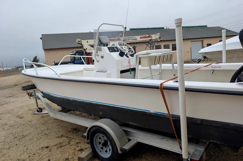 Slide: The Image of 2006 Twin Vee 19 BayCat boat on trailer, parked in a boatyard. - 7