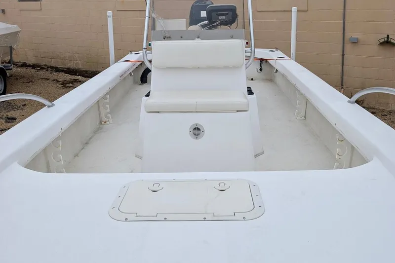 Slide: The Image of 2006 Twin Vee 19 BayCat boat interior with seating and storage compartments. - 8