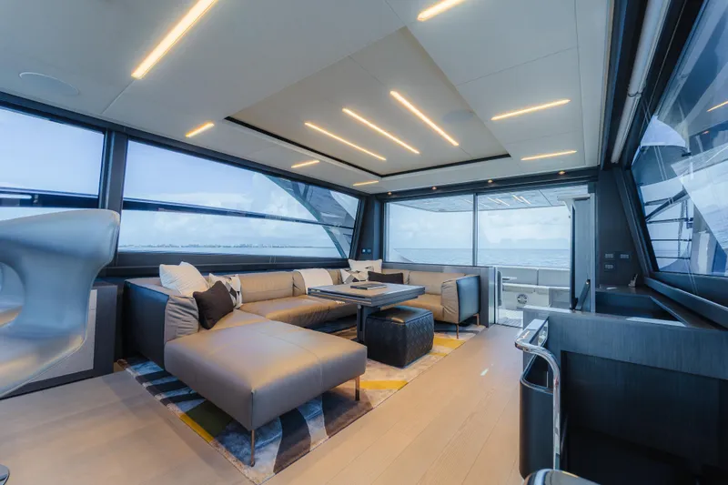 Slide: The Image of Luxurious interior of 2021 Pershing 8X yacht with modern seating and panoramic windows. - 10