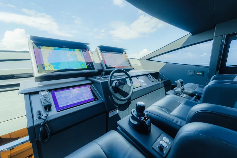 Slide: The Image of Cockpit of 2021 Pershing 8X yacht with advanced navigation systems and luxurious seating. - 12