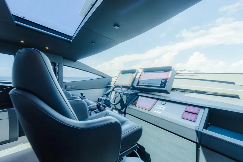 Slide: The Image of Luxurious 2021 Pershing 8X yacht cockpit with modern navigation displays and leather seating. - 13